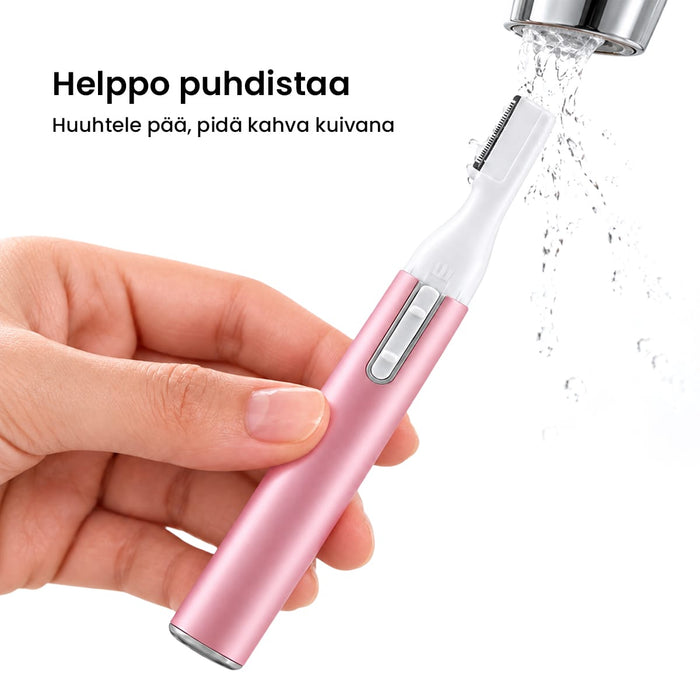 Käsi huuhtelee vaaleanpunaisen sähköisen tarkkuustrimmerin terää juoksevan veden alla.